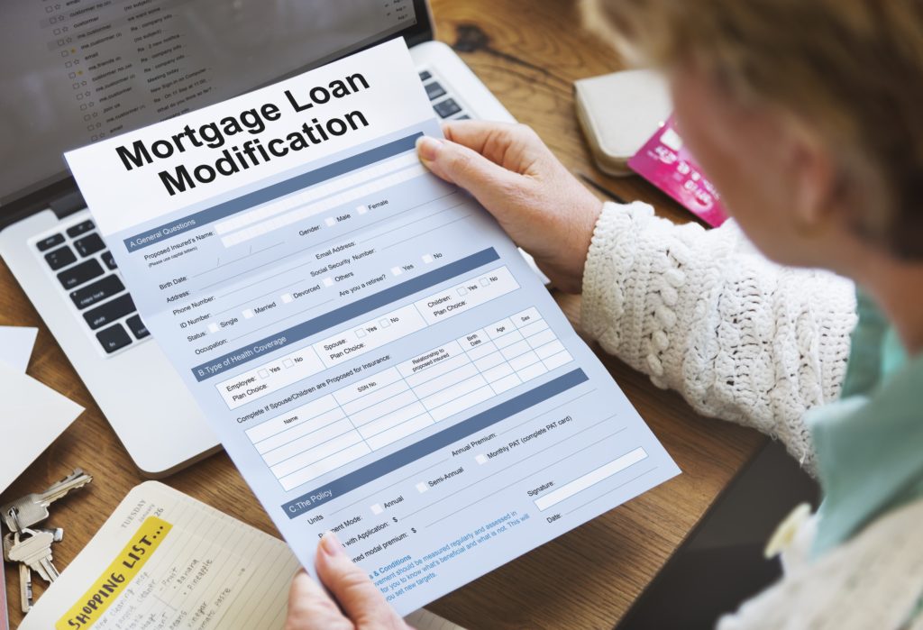 What Is the Difference Between a Loan Modification & Refinancing?