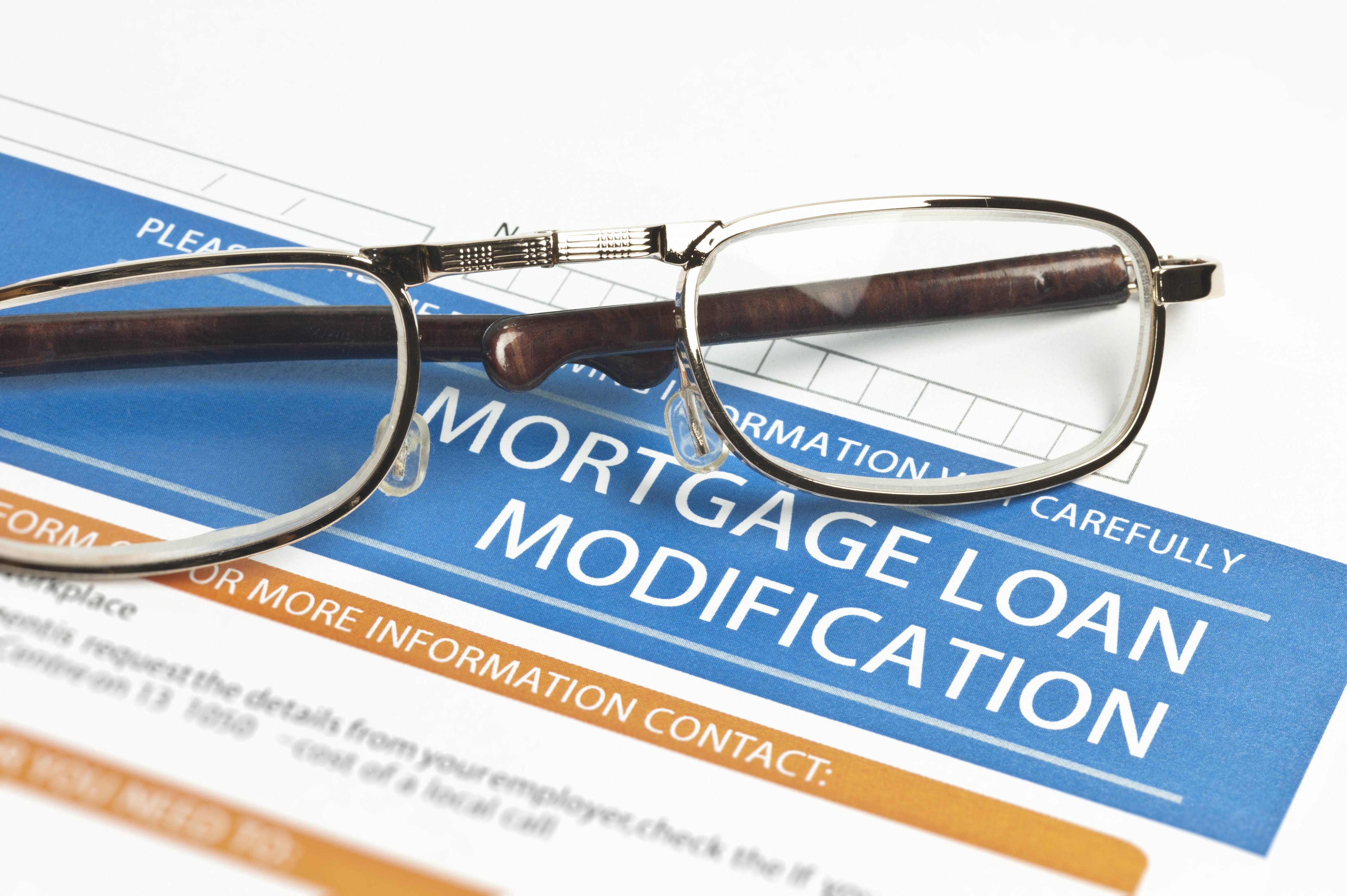 Mortgage loan modification form with eyeglasses on top.