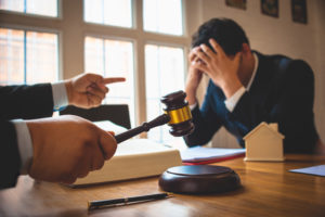 A sad man in a Westchester County foreclosure court, speaking to a Westchester county foreclosure lawyer.