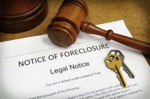 Westchester County foreclosure paperwork, gavel, and keys on the desk of a Westchester foreclosure defense attorney.