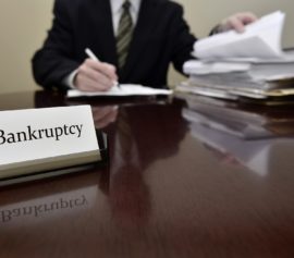 Bankruptcy lawyer sitting at desk.