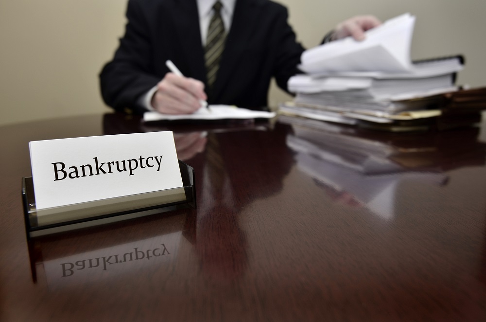 Bankruptcy lawyer sitting at desk.