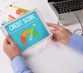 Man reading his credit score on a tab.