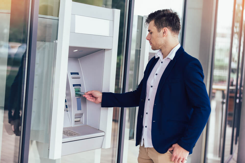 Man withdrawing his money at ATM